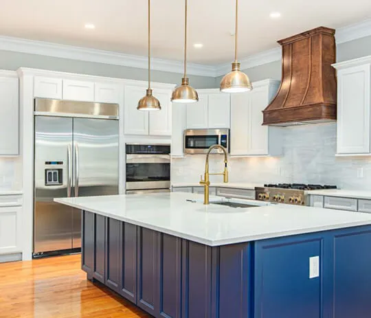 A kitchen with blue cabinets and white counter tops, creating a stylish and modern look.